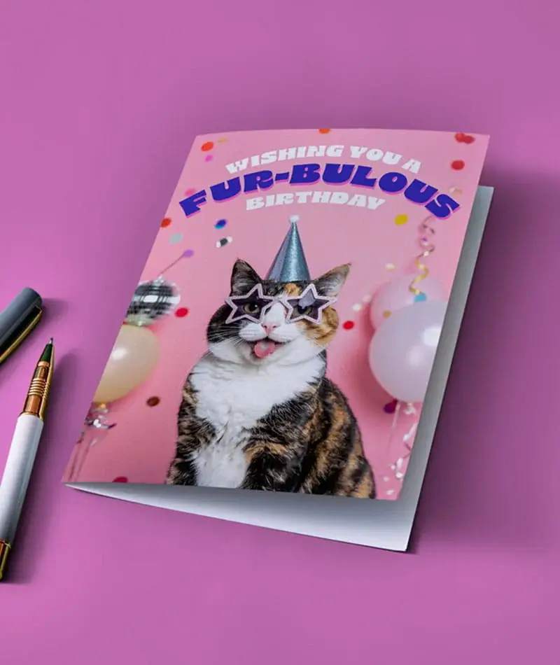 Pink birthday card featuring a cat wearing star-shaped sunglasses and a party hat with text Wishing You a Fur-bulous Birthday Pink birthday card featuring a cat wearing star-shaped sunglasses and a party hat with text Wishing You a Fur-bulous Birthday